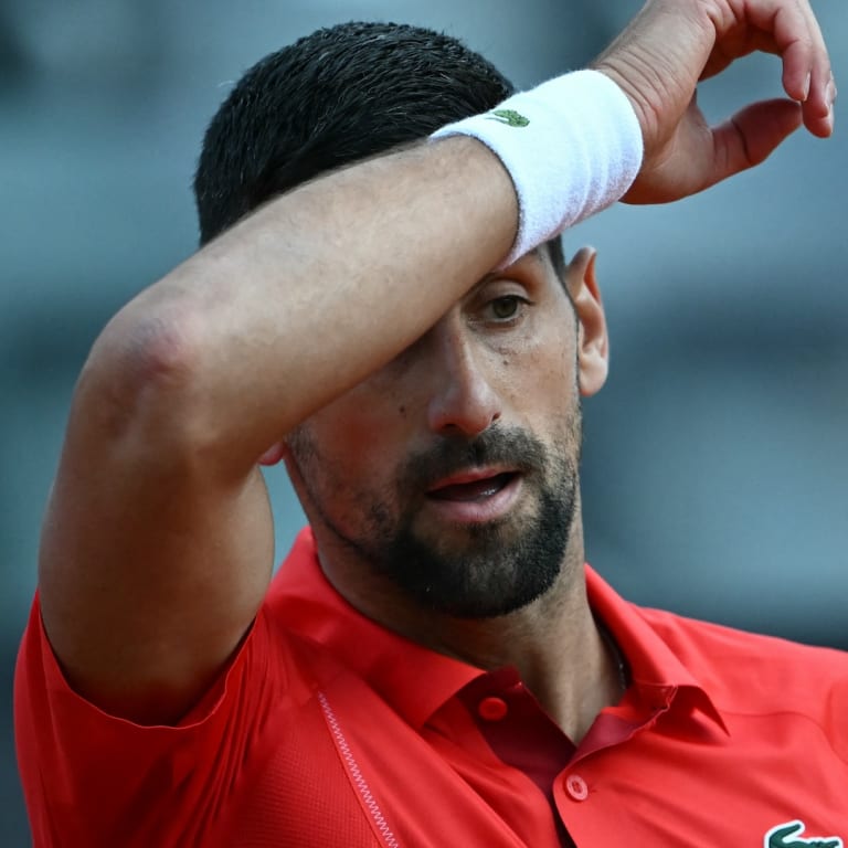 Novak hit by water bottle while signing autographs