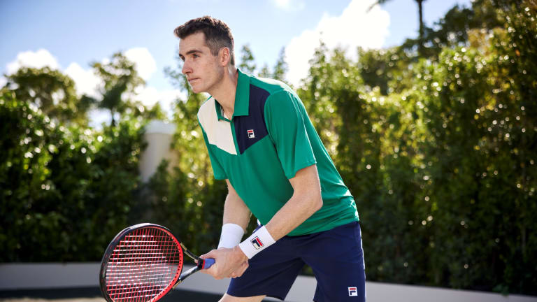 Here, John Isner models the Heritage Colorblock Polo with a pair of Heritage Woven Shorts in navy.
