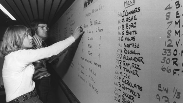 Bookmakers chalk up the odds for the winner of the 1975 men's Wimbledon tournament, at the William Hill betting shop.