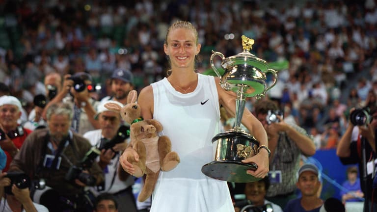 After her victory against Arantxa Sanchez-Vicario, Mary Pierce proudly holds up her trophy and stuffed kangaroo for winning the 1995 Australian Open final.