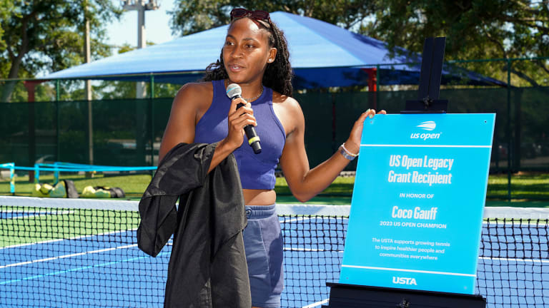 Coco Gauff at Pompey Park, with a sign commemorating that the courts were refurbished in honor of her 2023 US Open victory.