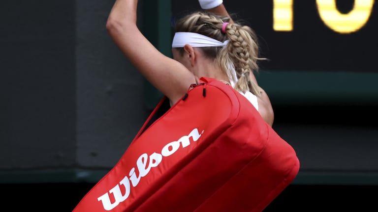 Azarenka gestures as she leaves to the disappointing sendoff.
