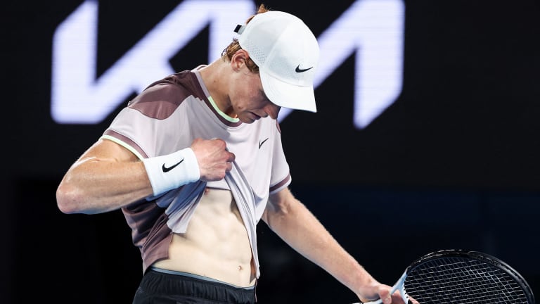 Sinner gestured to and massaged his abs during his quarterfinal match against Rublev at the Australian Open.