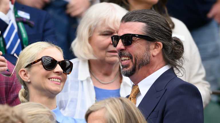 Dave Grohl, lead singer of the Foo Fighters, looked almost unrecognizable as he slicked back his long hair for the occasion.