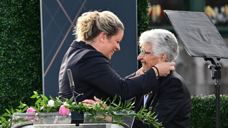 Judy Tegart Dalton, who couldn't attend the 2021 ceremony with her fellow Original 9 members, was recognized Saturday. She is greeted here by Honorary President, Kim Clijsters.