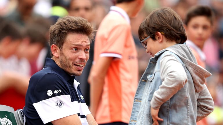 Mahut celebrates
singles win in Paris
with his son