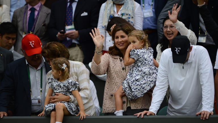 2012: Waving to the Wimbledon champion. Or to Myla and Charlene, just dad.