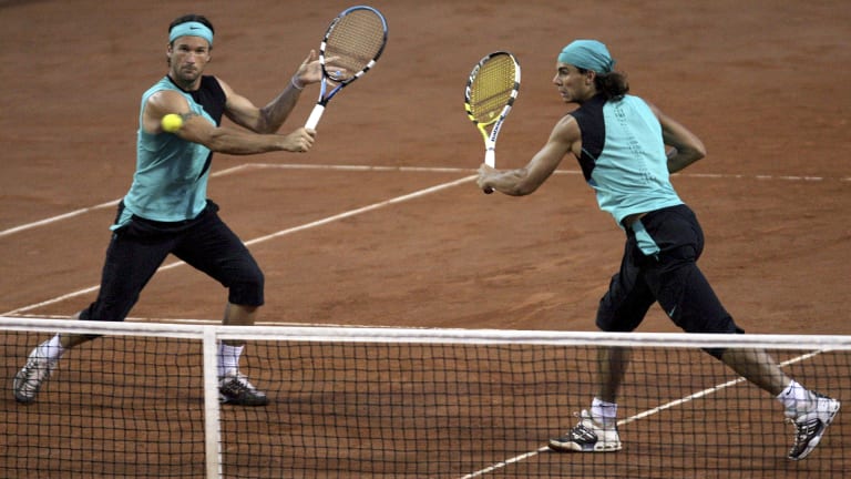At a doubles match in Rome, Nadal rocked a rare bandana as he wore a matching blue-and-black kit with fellow Mallorcan and future coach Carlos Moya.