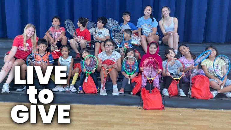 Lauryn and her friends pictured with the kids at her tennis camp, as they show off their tennis racquets.