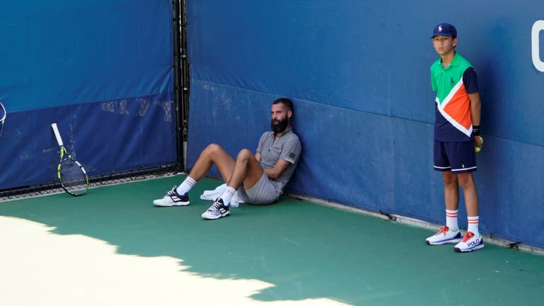 Paire finds some shade while a fan is tended to in the stands.