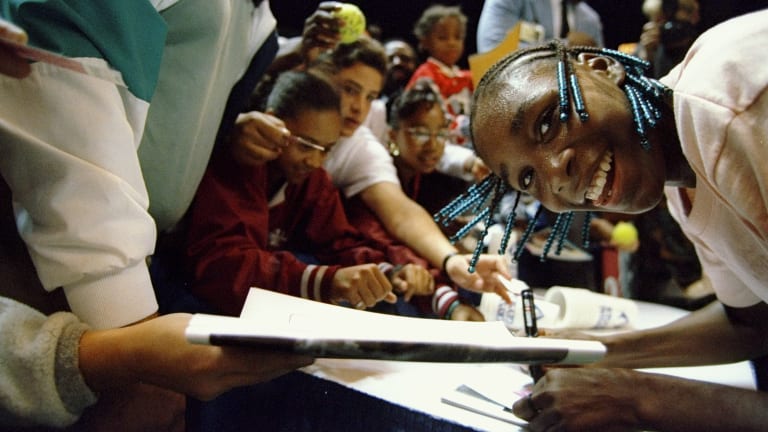 Venus Williams signs autographs after winning her WTA debut On October 31, 1994.