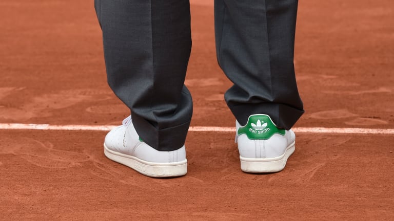 Stan Smith pictured wearing a pair of his shoes during a ceremony inducting former French tennis player, Amélie Mauresmo, into the International Tennis Hall of Fame.