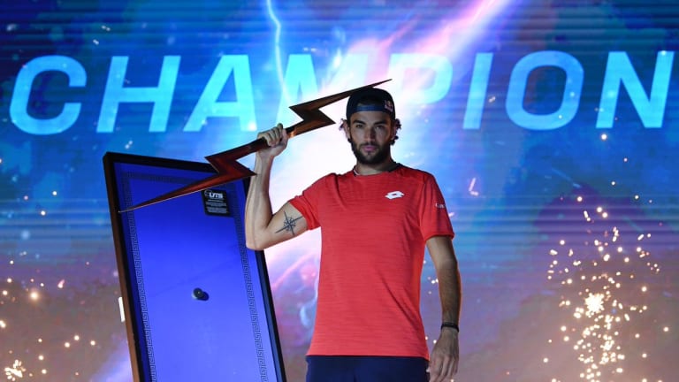 Berrettini poses with the event's lightning bolt trophy.