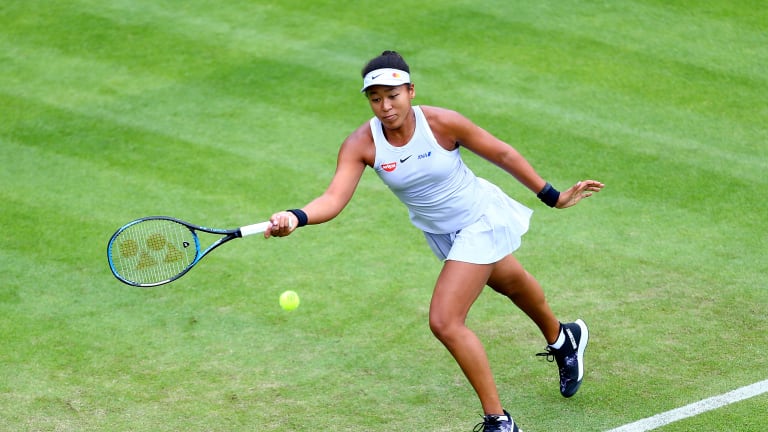 Osaka finds footing in grass debut with three-set win over Sakkari
