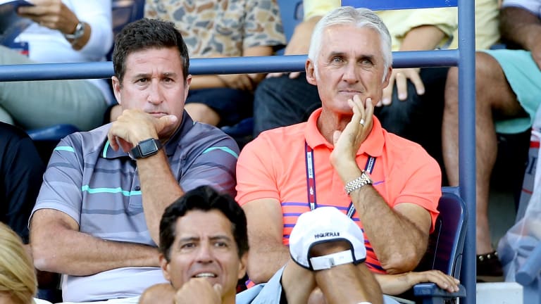 Alongside Jay Berger, then USTA Head of Men's Tennis, Higueras watches Donald Young at the 2015 US Open.