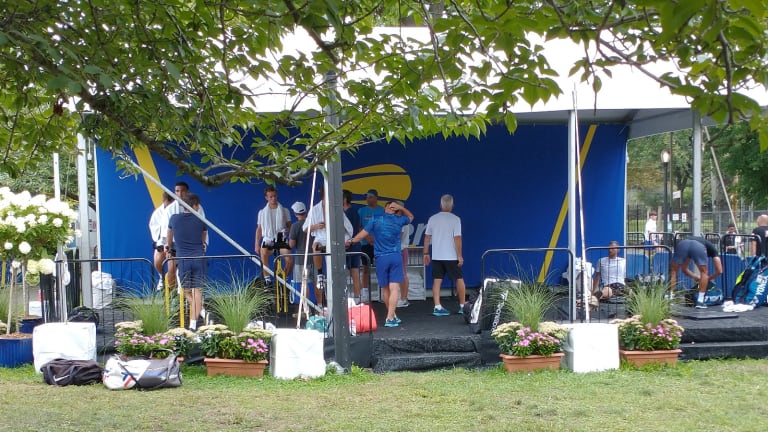 Off to one side, inside a large tent with a hard, carpeted floor, players stretched on the floor or rode bikes, cooling down while staring at their phones.