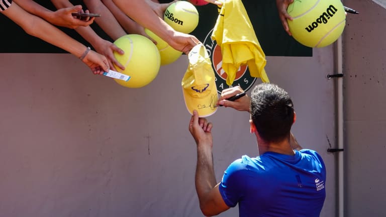 Some might say hanging this yellow hat down for Novak's ink was one bold move, but the Belgrade native obliged when heading towards the other side of the baseline.