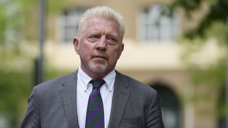 Wearing a striped tie in Wimbledon's purple and green colors, Becker was convicted earlier this month on four charges.