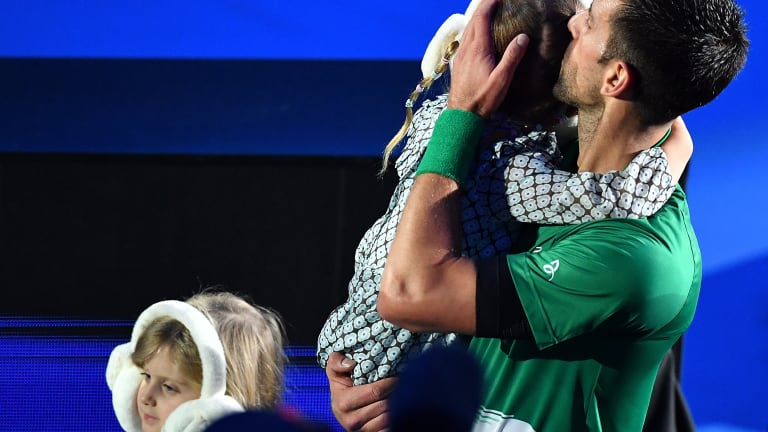 As a fabulous father and top player, Novak Djokovic celebrates his victory against Casper Ruud in the ATP Finals while tending to his daughter.