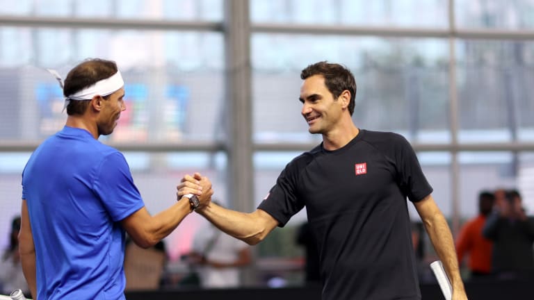 Nadal and Federer meet at the net after the practice.