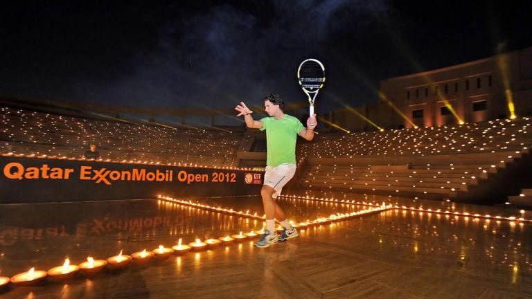 The pair played a match under the light of over 4,000 Roman candles in celebration of the 20th anniversary of men’s professional tennis in Doha.