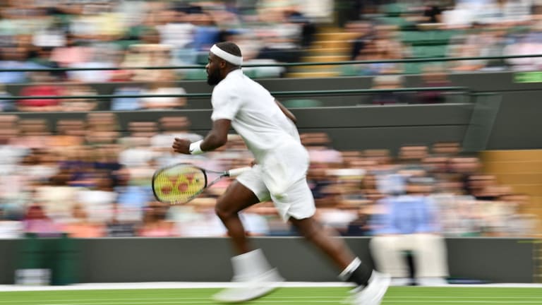 Frances Tiafoe chases down ball at Wimbledon 2021