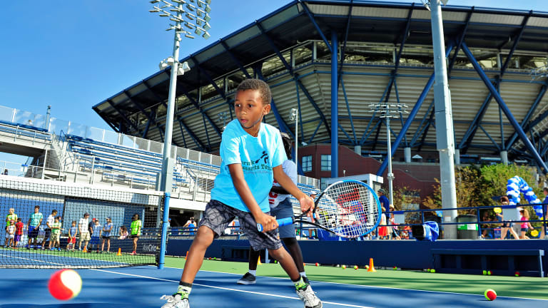 A young fan participates in a USTA event prior to the start of the US Open.
