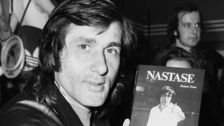 Ilie Nastase holds up a copy of his biography penned by Evans and published in 1978.