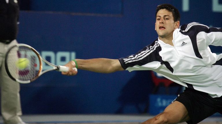 Novak Djokovic shows off his flexibility and movement as he lunges to return the ball during the 2006 Hopman Cup.