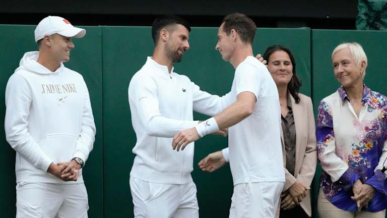 Murray embraces Djokovic after making his way down the line of past and current players who were present.