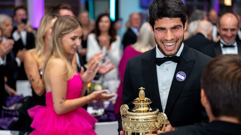 Alcaraz was all smiles as he showed off the men's singles trophy during the Wimbledon champion's dinner.