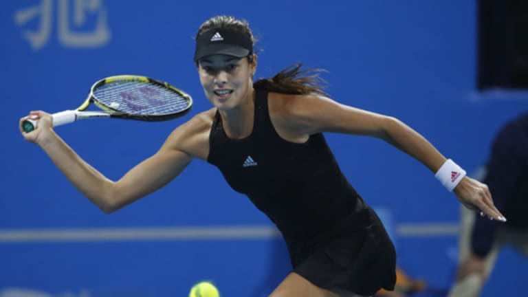 Ana Ivanovic of Serbia returns a shot against Maria Sharapova of Russia during the semi final match of the China Open tennis tournament at the National Tennis Stadium in Beijing, China, Saturday, Oct. 4, 2014. (AP Photo/Vincent Thian)