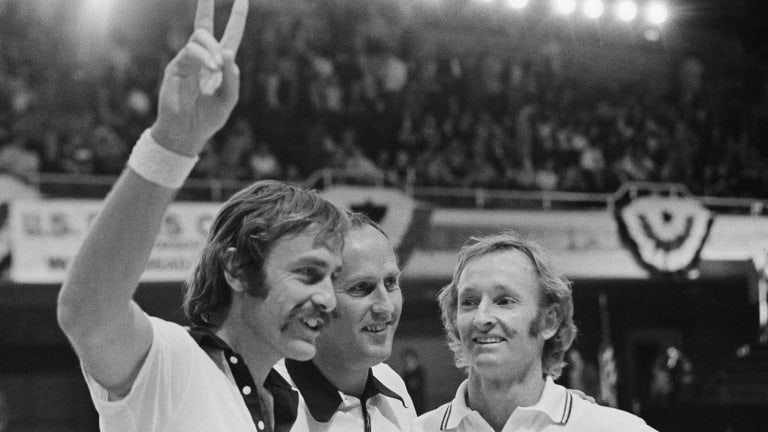 Australian John Newcombe, left, flashes the victory sign after he and Rod Laver, right, defeated Stan Smith and Erik Van Dillen of the United States.