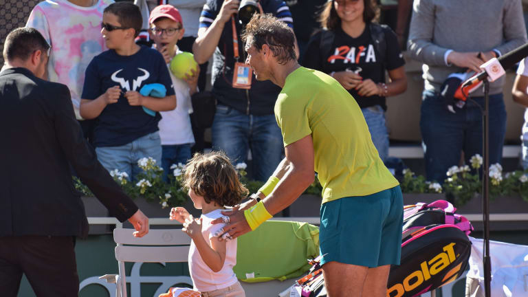 Nadal greeted by an adorable pitch invader after his third-round match.