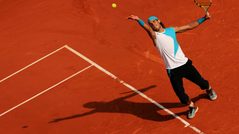 Nadal and his very long shorts in action during 2007 Roland Garros