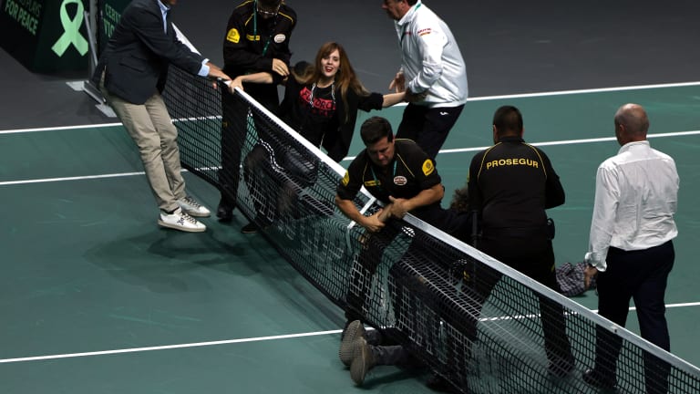 In an increasingly familiar move, the protesters made it onto the court and attempted to tie themselves to the net before being apprehended.