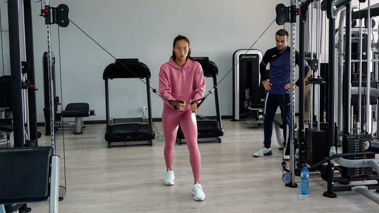 Riba guides Zheng through a gym session at the Els Gorchs Tennis Club.