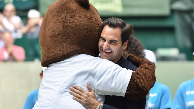 Federer hugs mascot Gerry Berry after being introduced Wednesday.